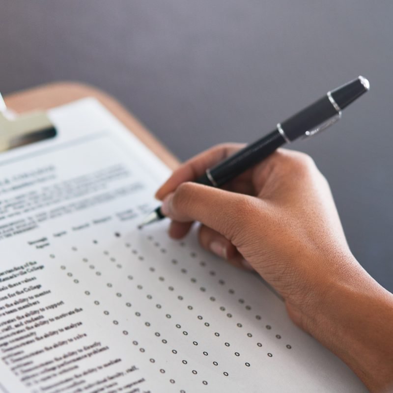 Completing the survey. Cropped shot of an unrecognizable businesswoman filling in a questionnaire.