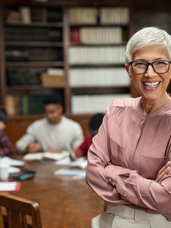 Smiling university professor in library